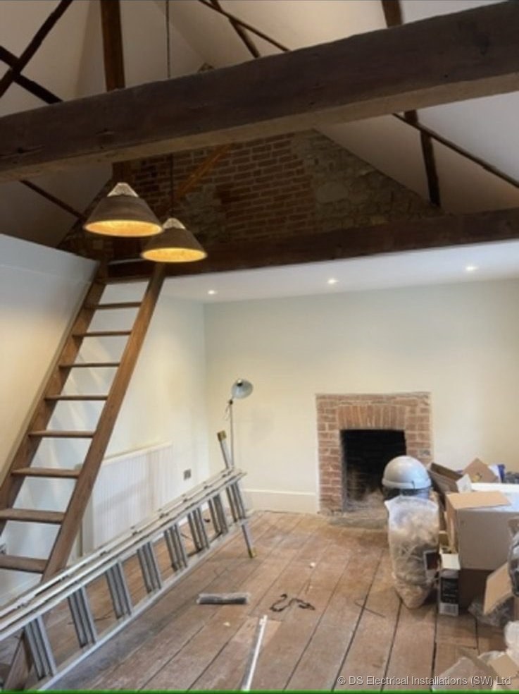 Barn conversion with pendant lighting and exposed beams