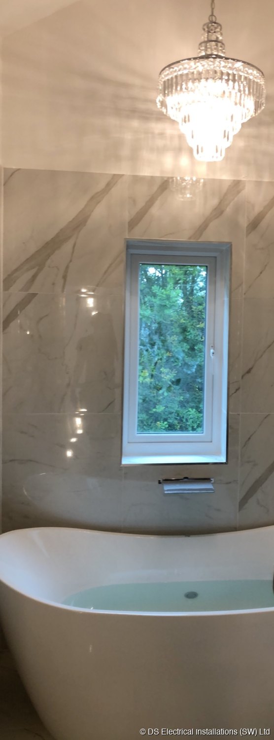 Chandelier over freestanding bath