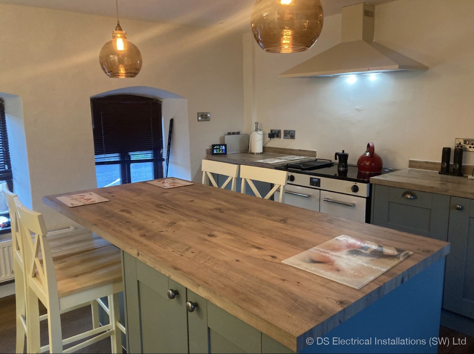 Blue shaker kitchen, amber pendants