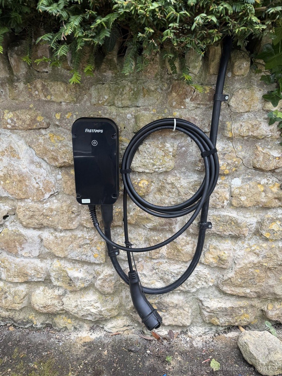 Home charge point on a Somerset stone wall with the cable holstered