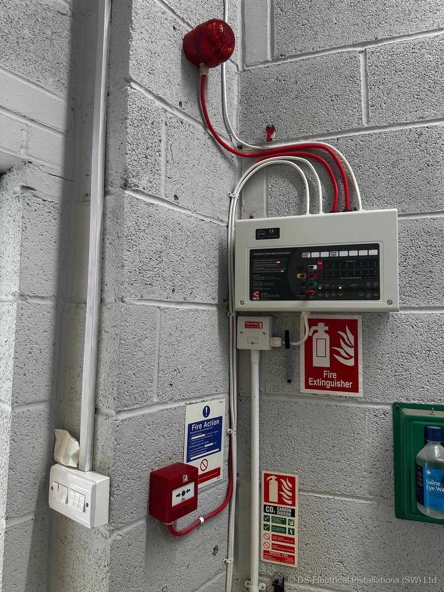 Commercial fire alarm control panel with sounder and manual call point, installed by DS Electrical Installations (SW) Ltd