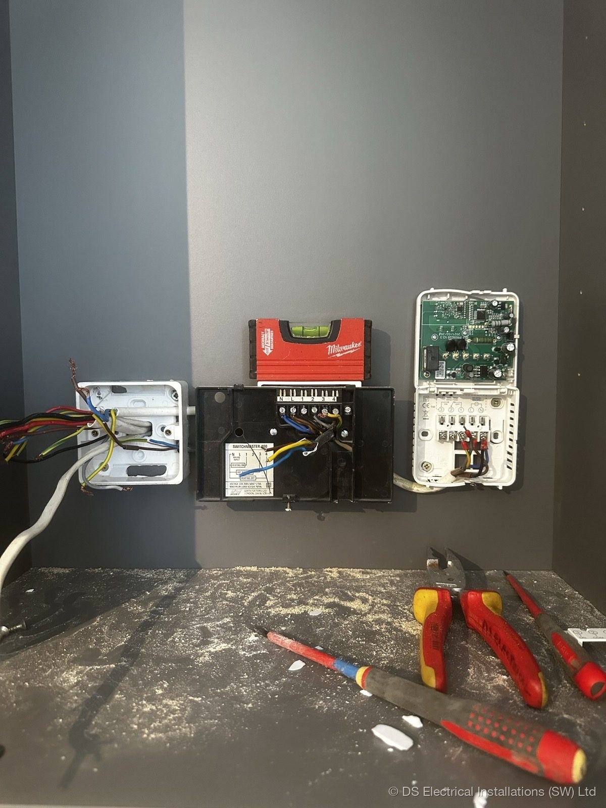 Wall-mounted control unit being wired at second fix by DS Electrical Installations (SW) Ltd
