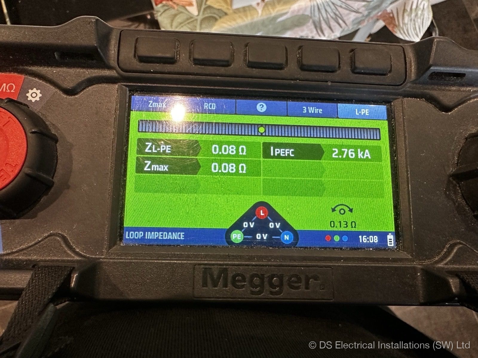 Megger multifunction tester showing a 0.08 ohm earth fault loop impedance and 2.76 kA prospective fault current reading during testing