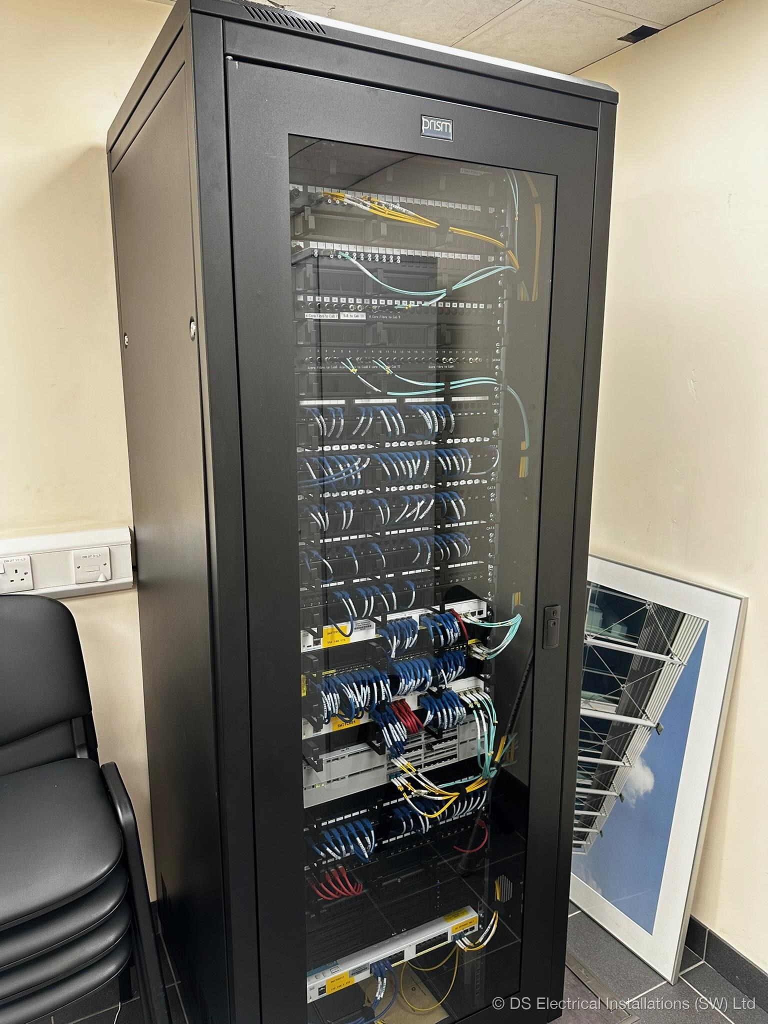 Floor-standing comms cabinet with dressed Cat6 patch leads, installed by DS Electrical Installations (SW) Ltd