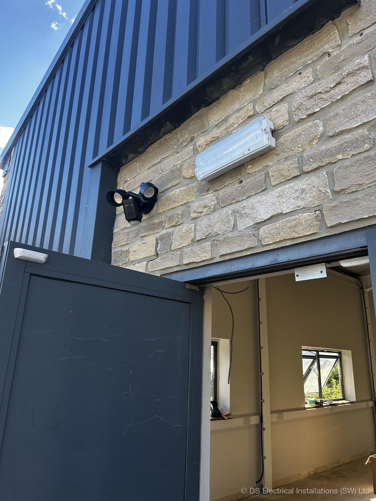 Security floodlight on stone building