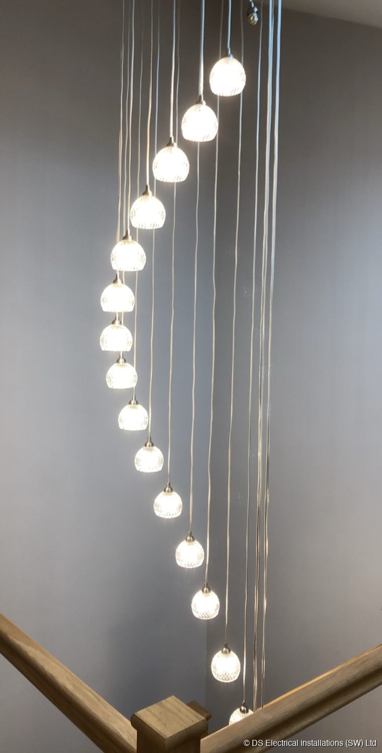 Crystal chandelier cascading down a spiral staircase