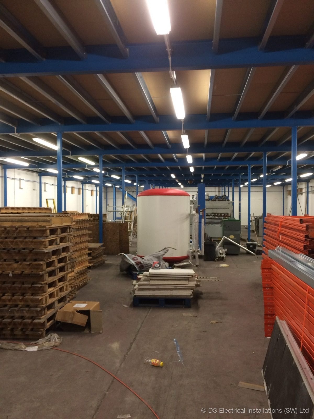 LED batten lighting installed across a warehouse ceiling during a full re-light